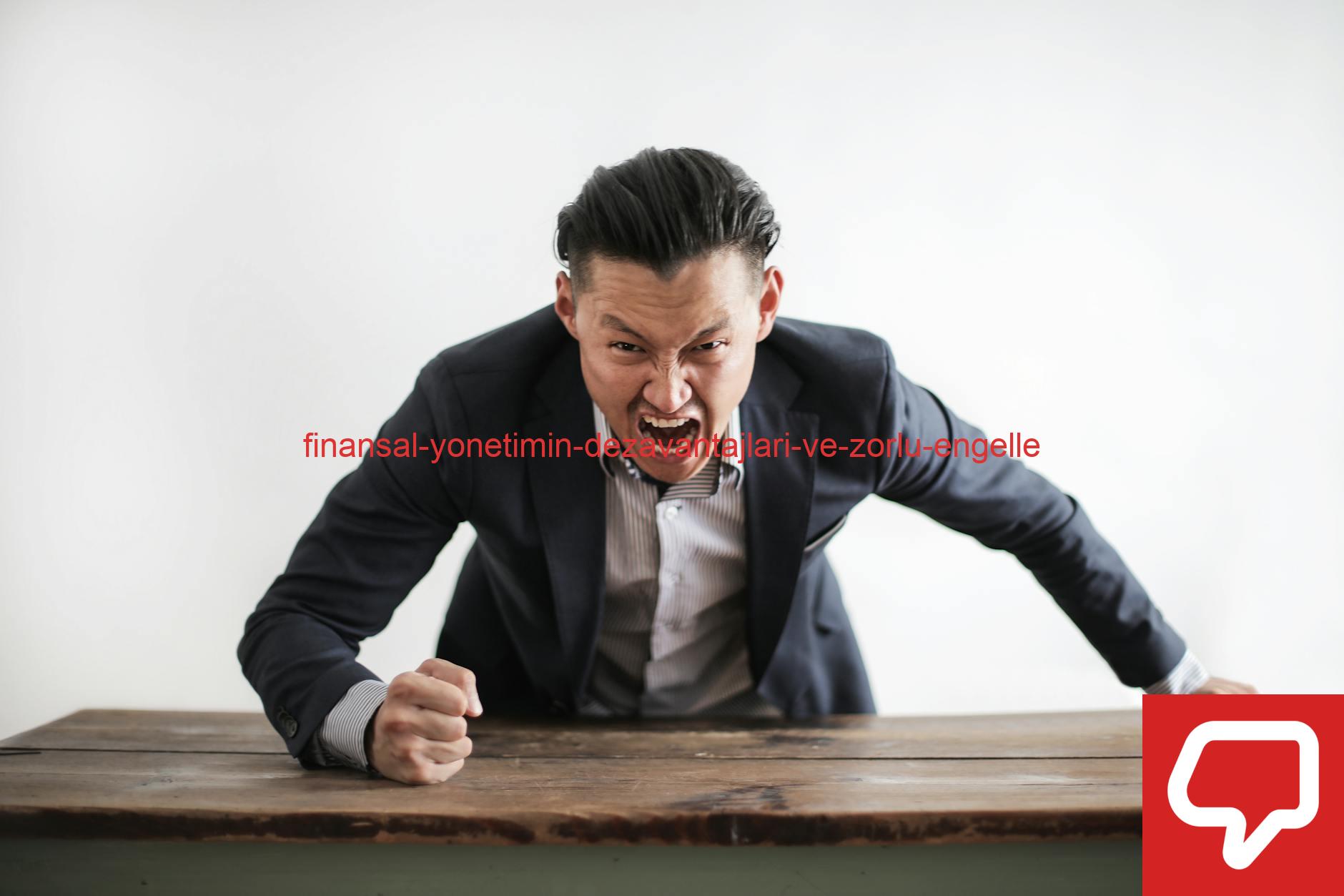 Expressive angry businessman in formal suit looking at camera and screaming with madness while hitting desk with fist