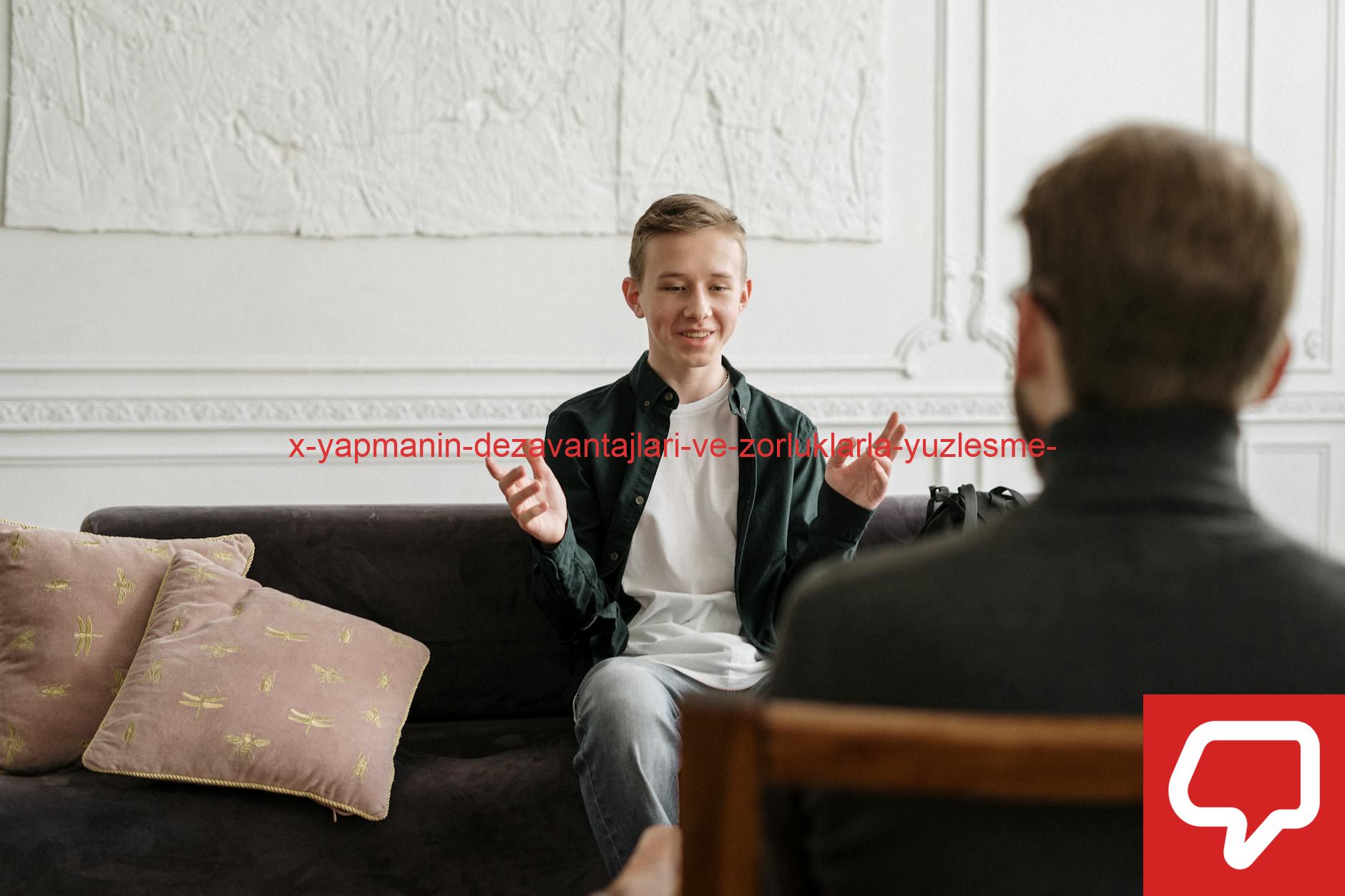 Teen in discussion with therapist on a sofa during a counseling session indoors.