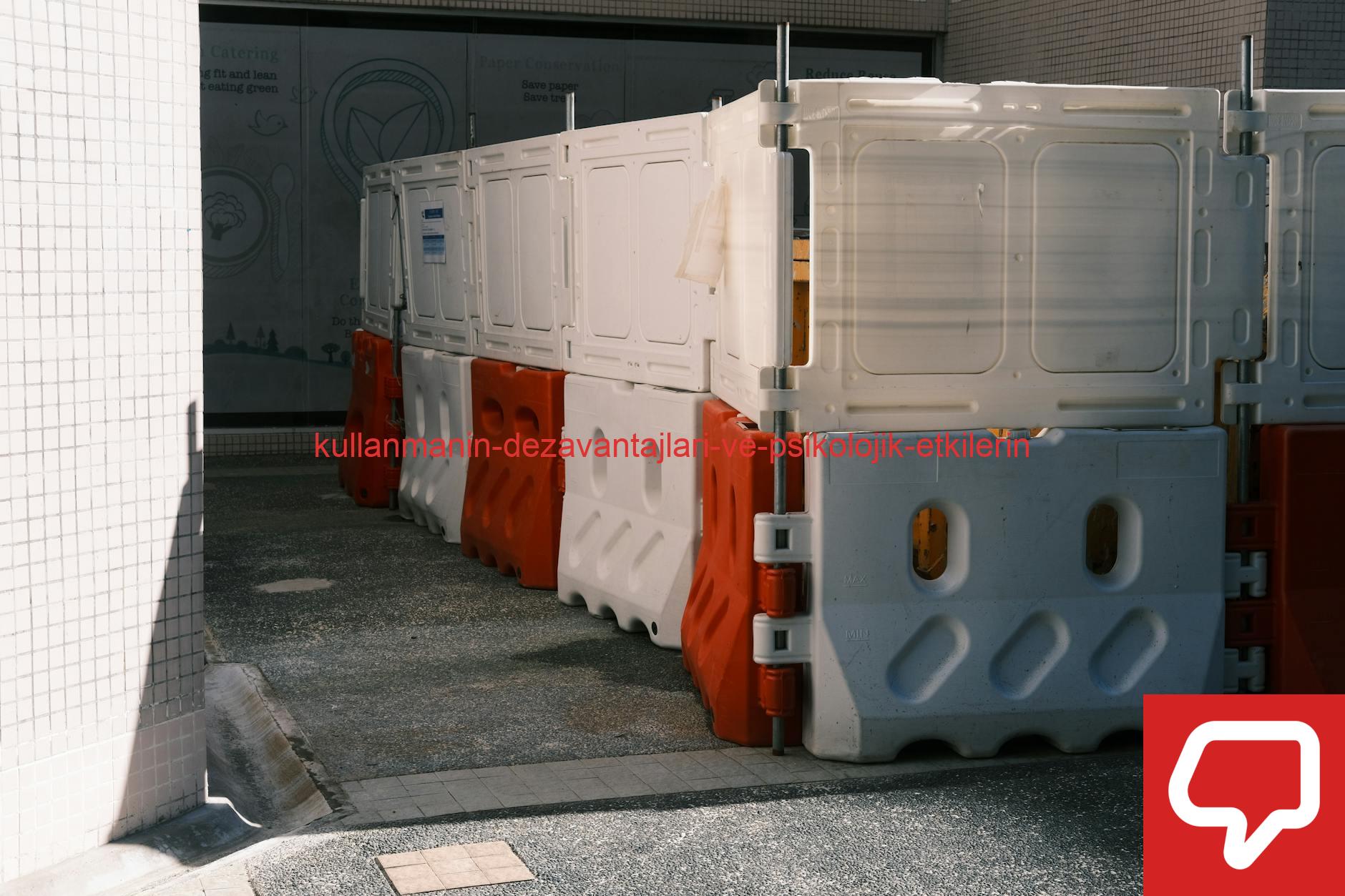 Plastic roadblock barriers with red and white colors in an urban area.