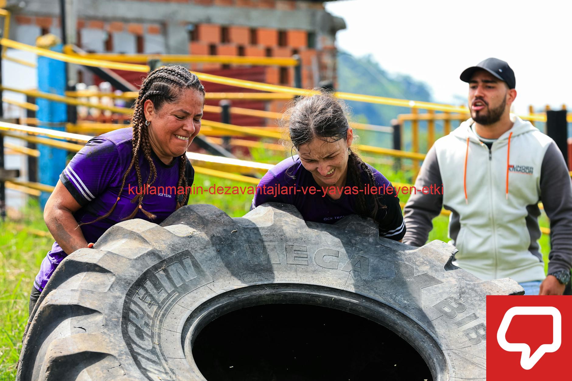 Two women and a man engage in an outdoor fitness session flipping a large tire.