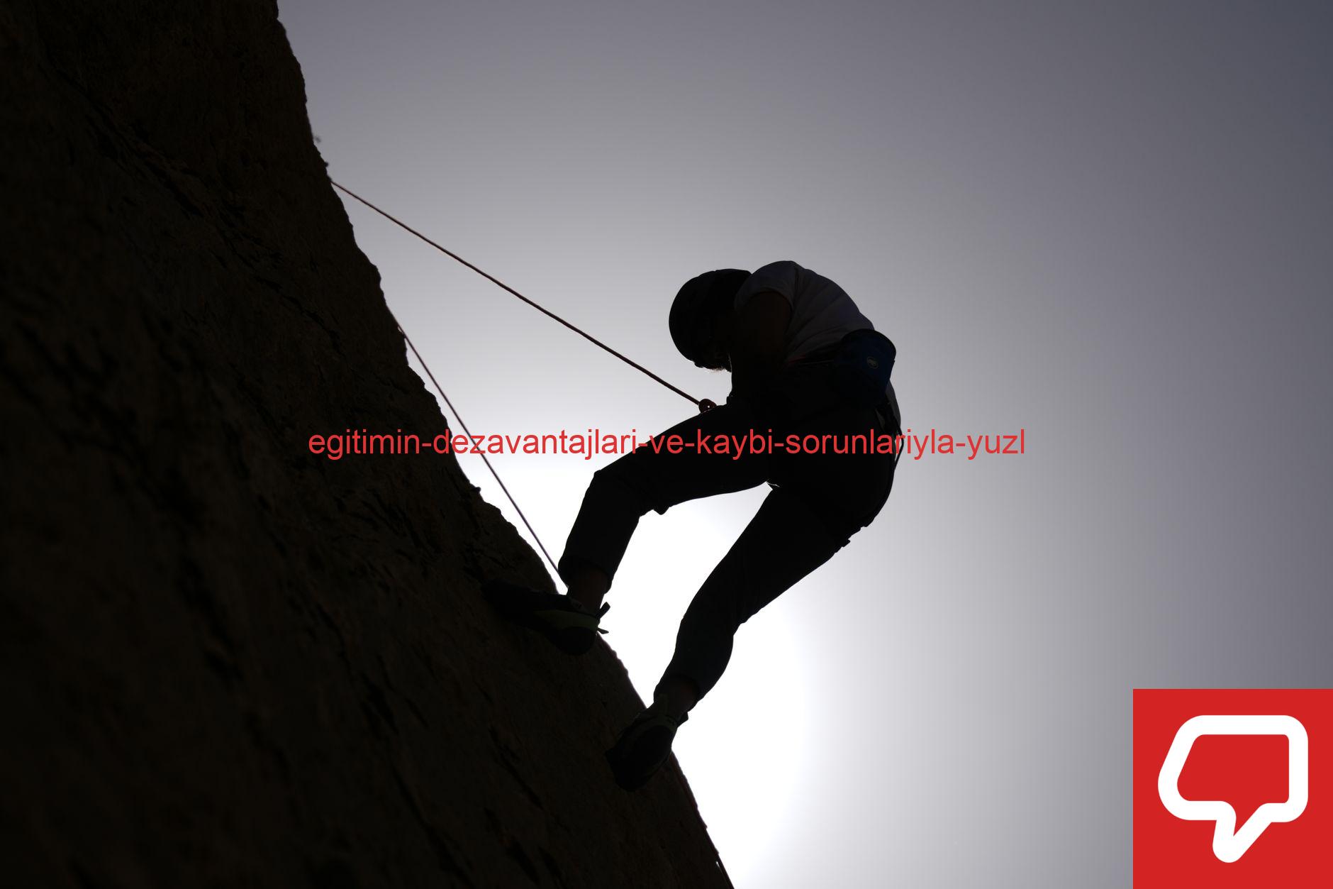 Silhouette of a person rock climbing in Damascus, Syria, against a bright sky.