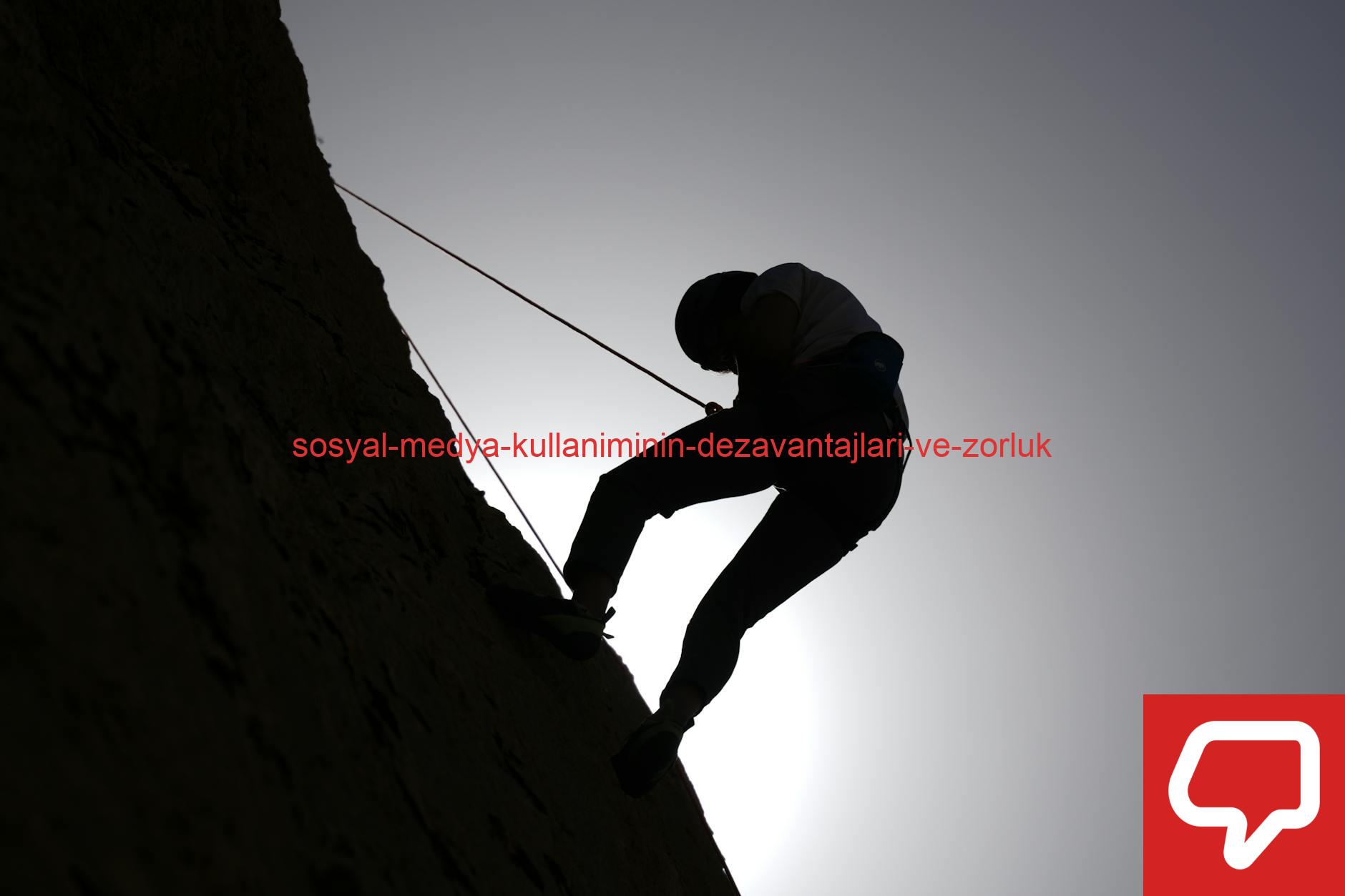 Silhouette of a person rock climbing in Damascus, Syria, against a bright sky.